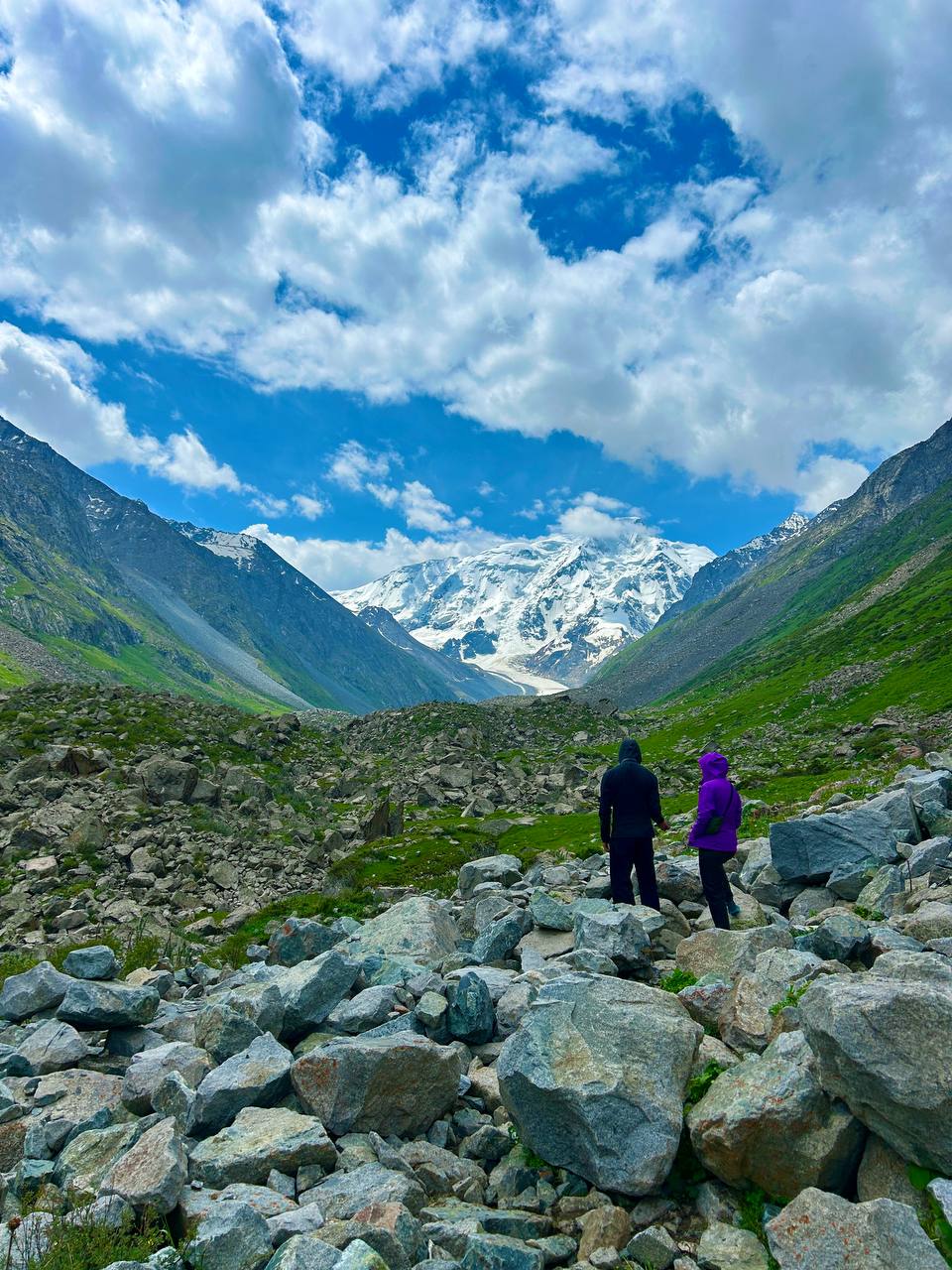 Two guests looking at glacier and snowy peak